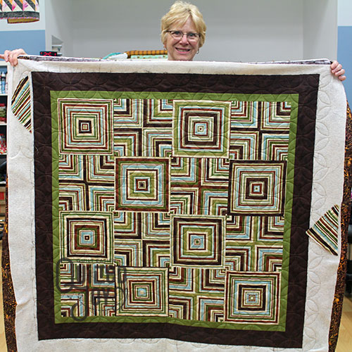 Carol's quartered stripe quilt after longarm quilting it at Quilted Joy
