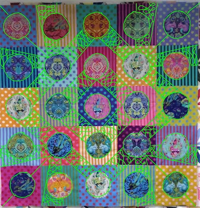 image of a colorful quilt using Tula Pink All Stars and polka dot fabrics with quilting design ideas drawn on by Angela Huffman