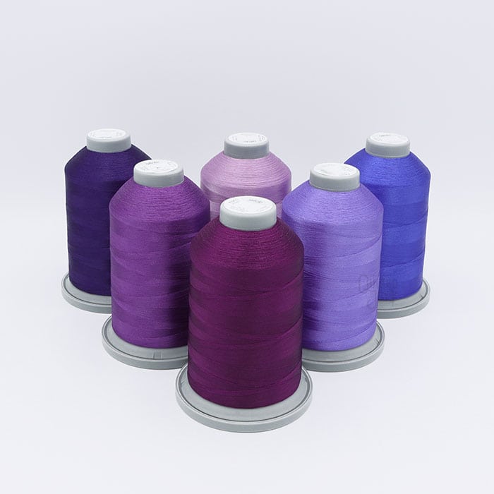 Glide Thread Color Block Bundle - Purple - six cones of purple Glide thread on a white background