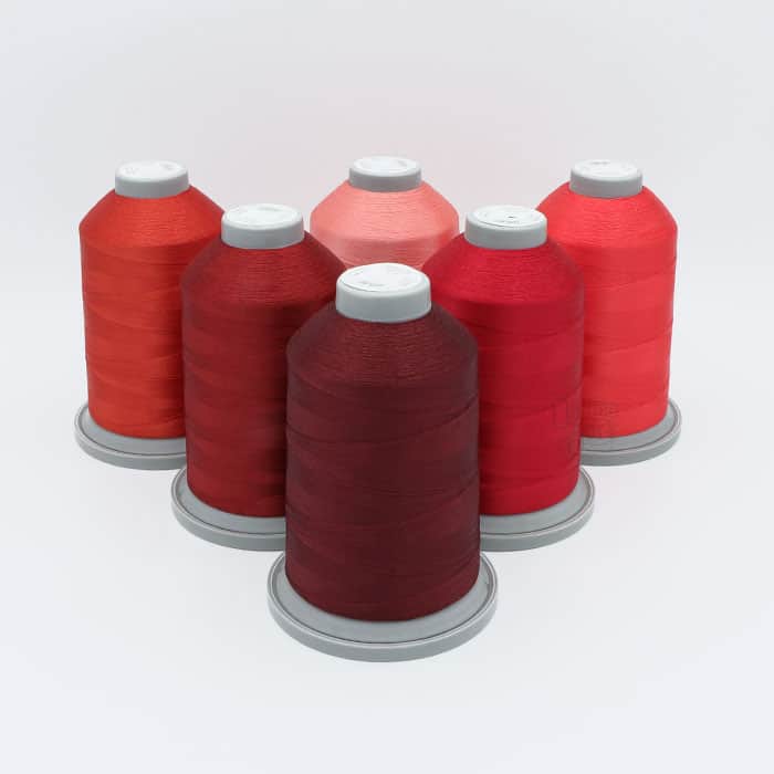 Glide Thread Color Block Bundle - Red - six cones of red Glide thread on a white background