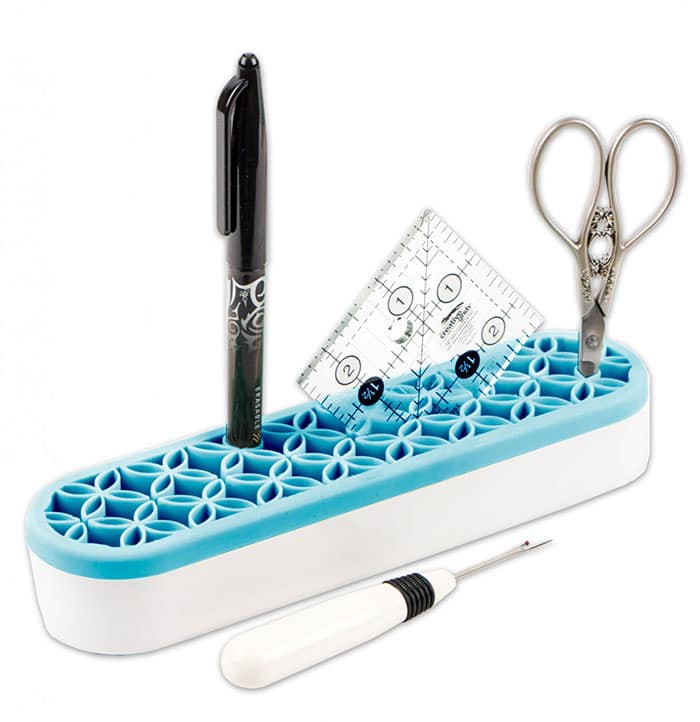 image of Oh Sew! Organized Stash 'N Store Aqua storing a fabric pen, piecing ruler, snips, and a seam ripper on a white background