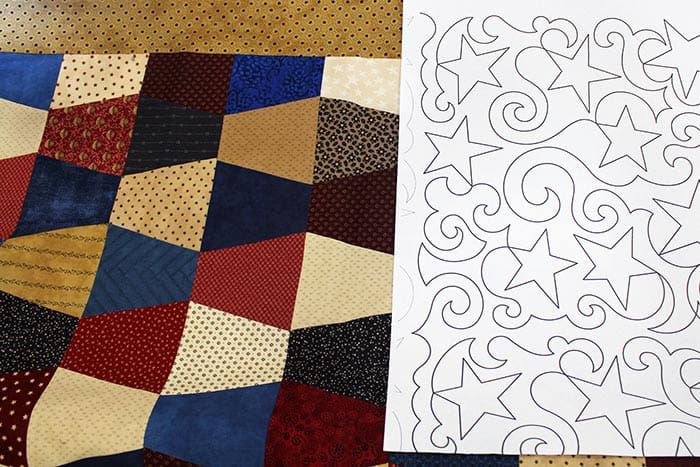 image of a patriotic tumbler block quilt with the Swirly Stars paper pantograph